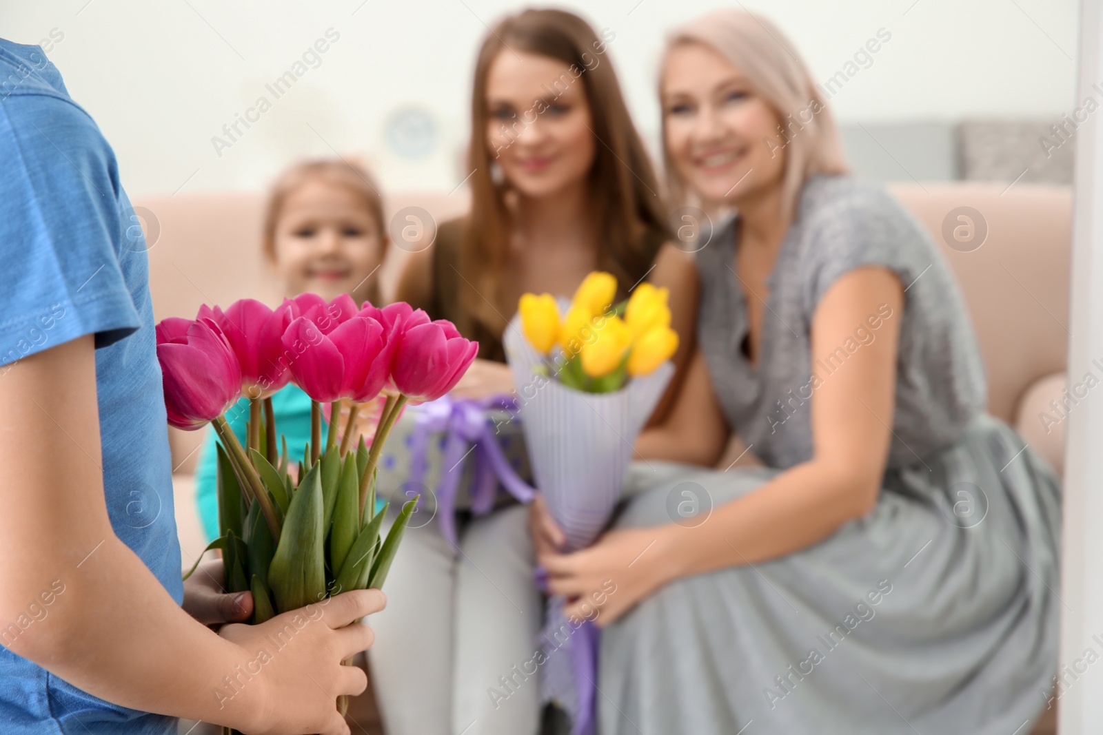 Photo of Little boy congratulating his family at home