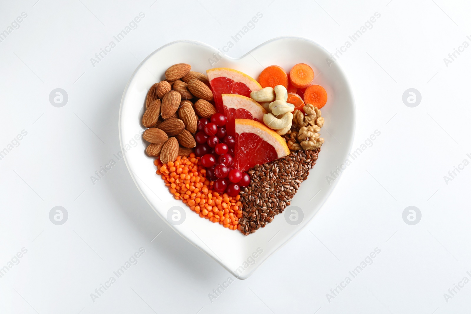 Photo of Plate with products for heart-healthy diet on white background, top view