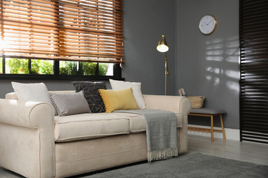 Photo of Stylish living room interior with comfortable sofa near window