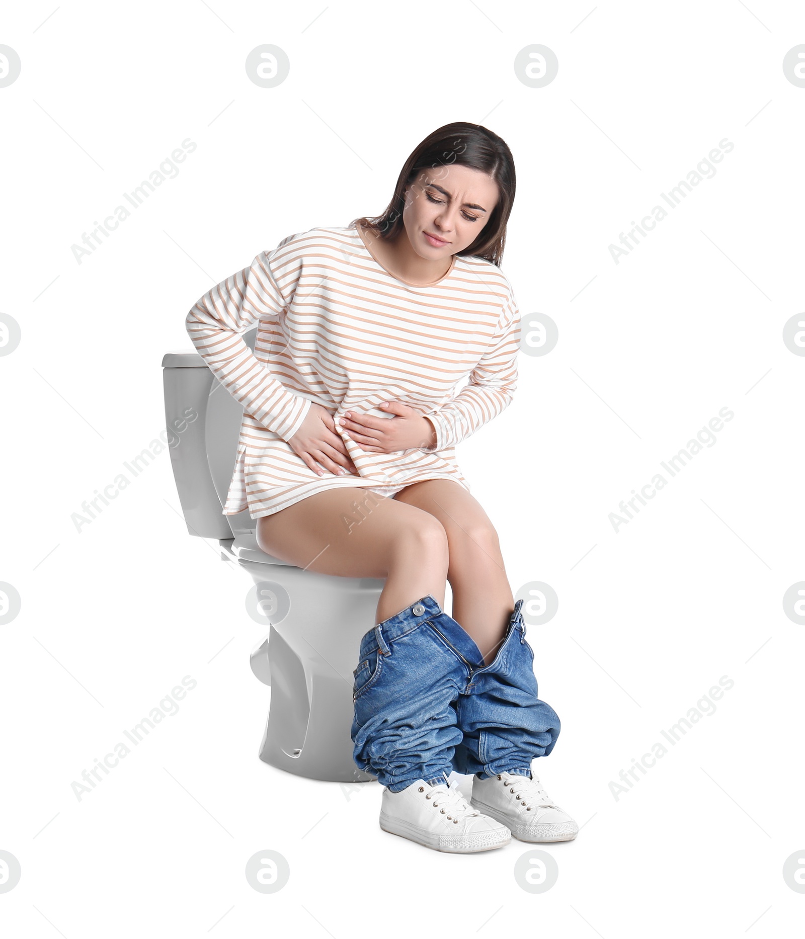 Photo of Woman with stomach ache sitting on toilet bowl, white background