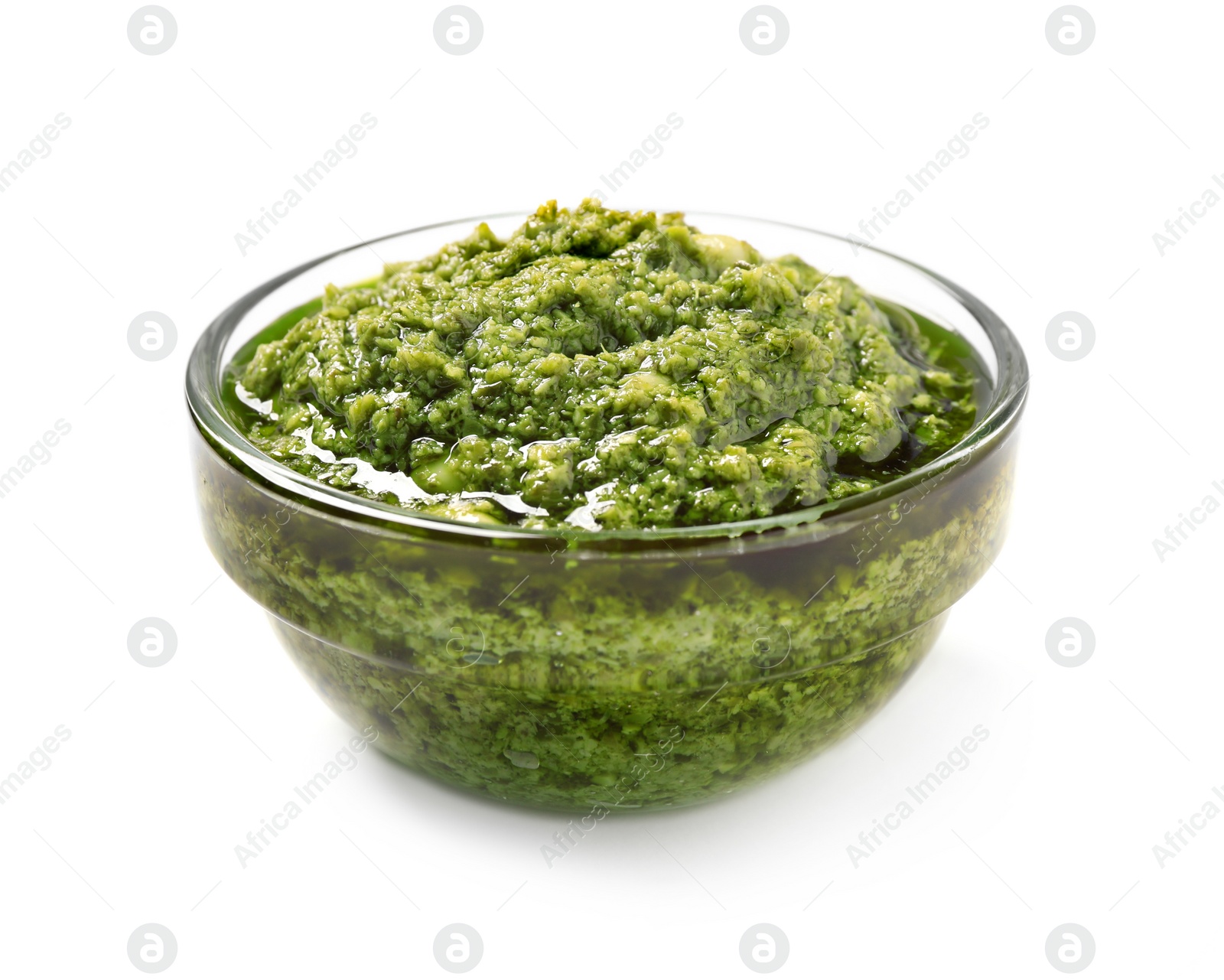 Photo of Bowl of tasty arugula pesto on white background