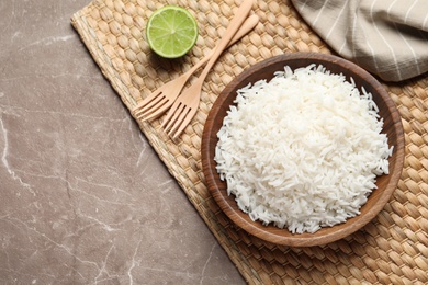 Photo of Plate of tasty cooked rice served on table, flat lay. Space for text