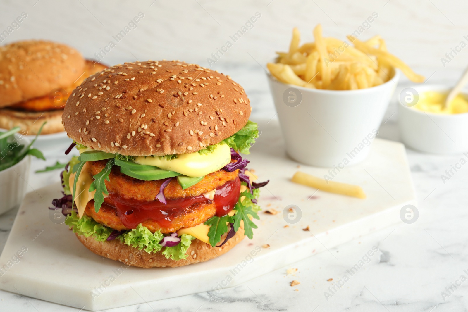 Photo of Vegan burger with carrot patties served on table. Space for text