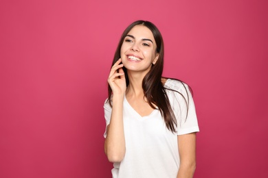 Photo of Portrait of young woman laughing on color background