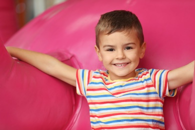 Cute little child playing at indoor amusement park