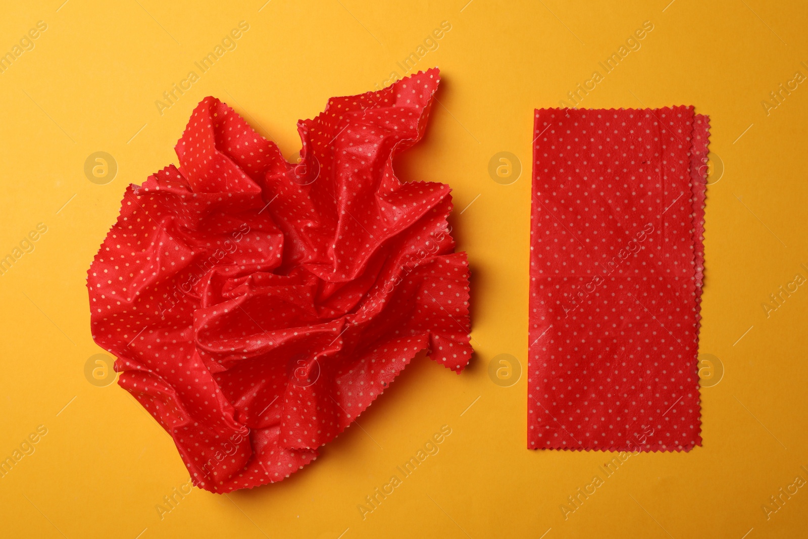 Photo of Beeswax food wraps on yellow background, flat lay