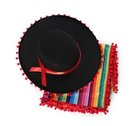 Photo of Mexican sombrero hat and colorful poncho isolated on white, top view