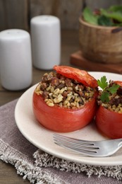 Photo of Delicious stuffed tomatoes with minced beef, bulgur and mushrooms served on table, closeup