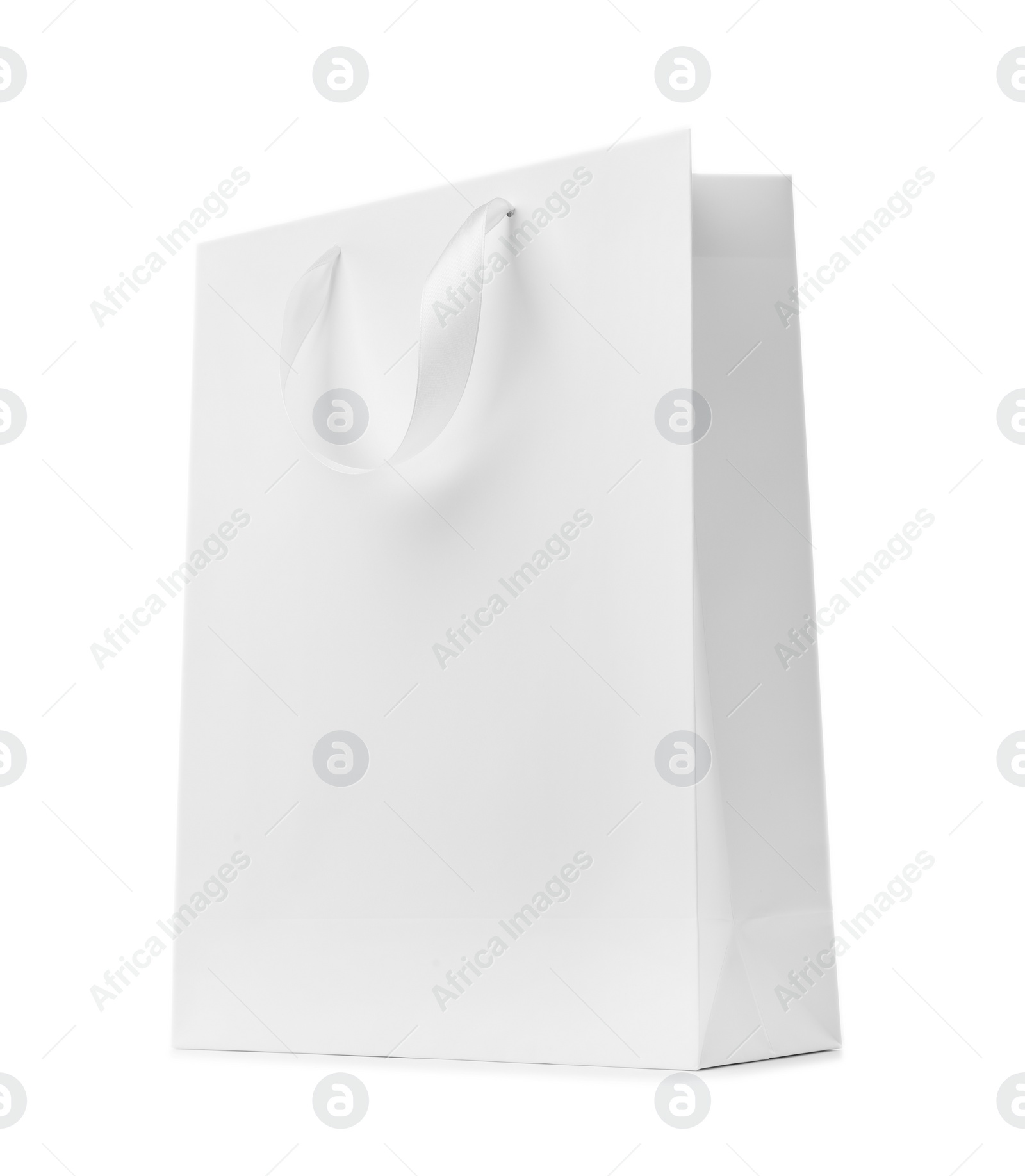 Photo of Paper shopping bag with ribbon handles on white background. Mockup for design