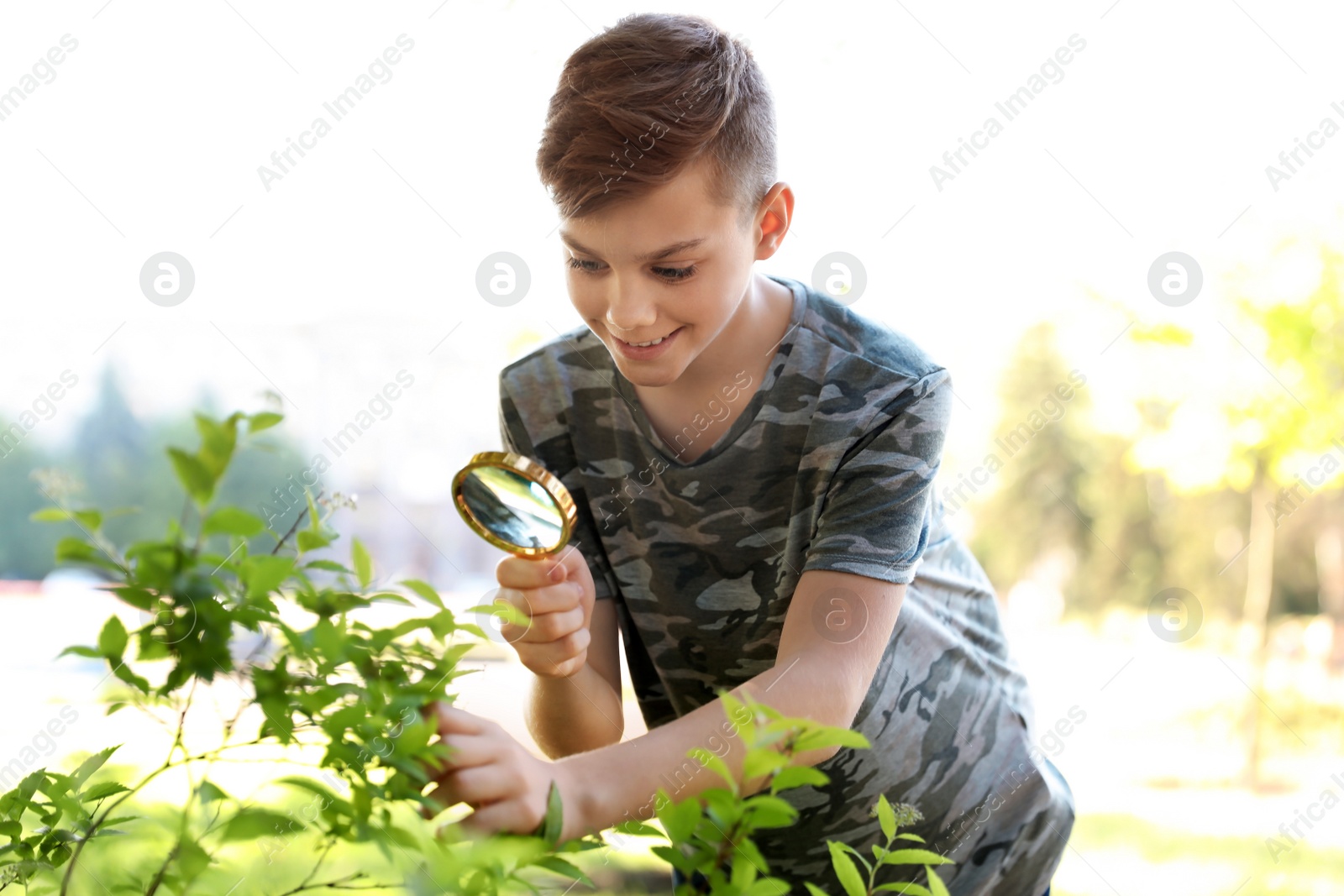 Photo of Teenage boy exploring bush outdoors. Summer camp