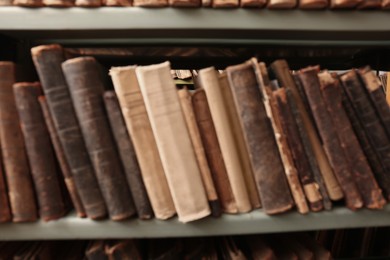 Photo of Blurred view of old books on shelf in library