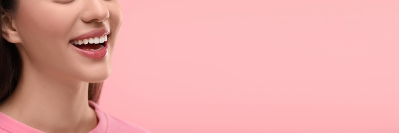 Woman with clean teeth smiling on pink background, closeup. Banner design with space for text