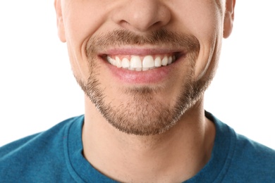 Smiling man with perfect teeth on white background, closeup