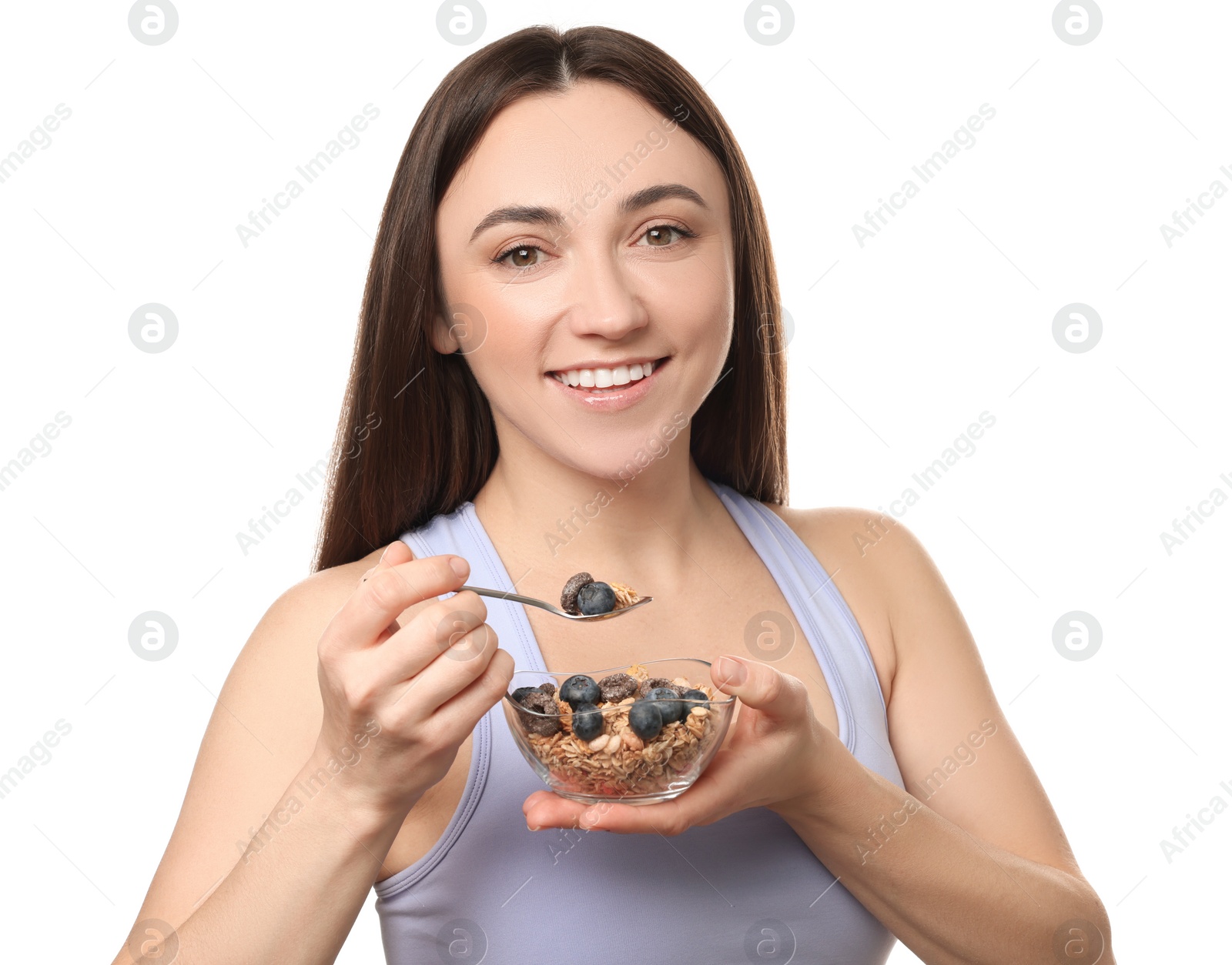 Photo of Happy woman eating tasty granola with fresh berries on white background