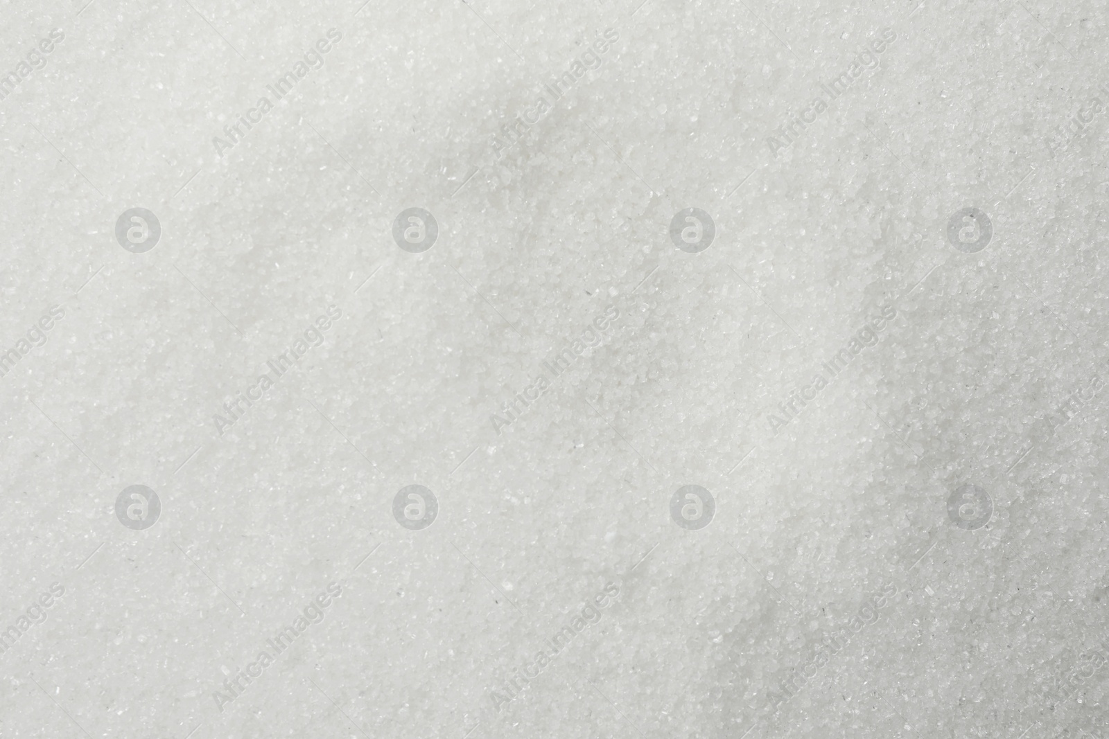 Photo of White granulated sugar as background, top view