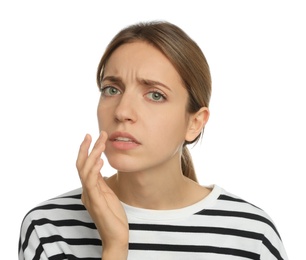 Photo of Woman with herpes applying cream onto lip against white background