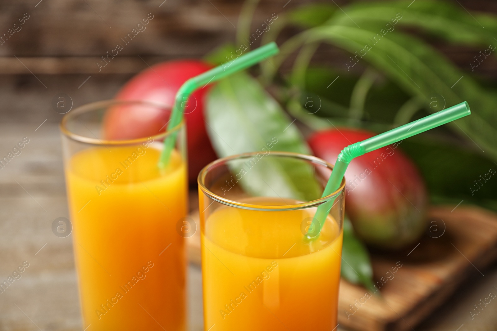 Photo of Fresh delicious mango drink on table, closeup