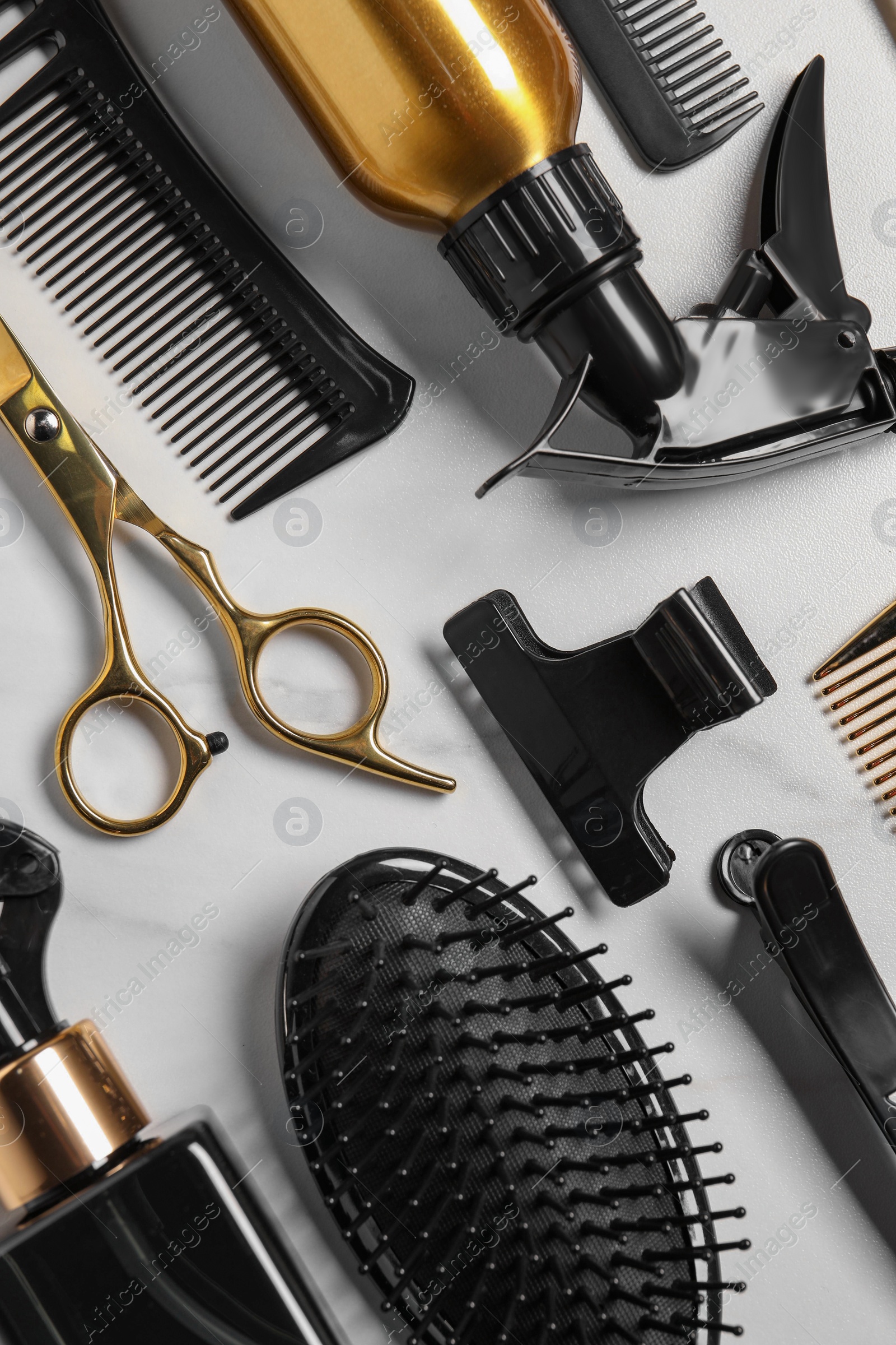 Photo of Hairdressing tools on white table, flat lay