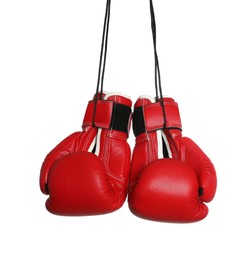 Photo of Pair of boxing gloves hanging on white background