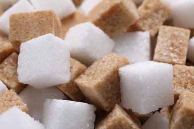 White and brown sugar cubes as background, closeup