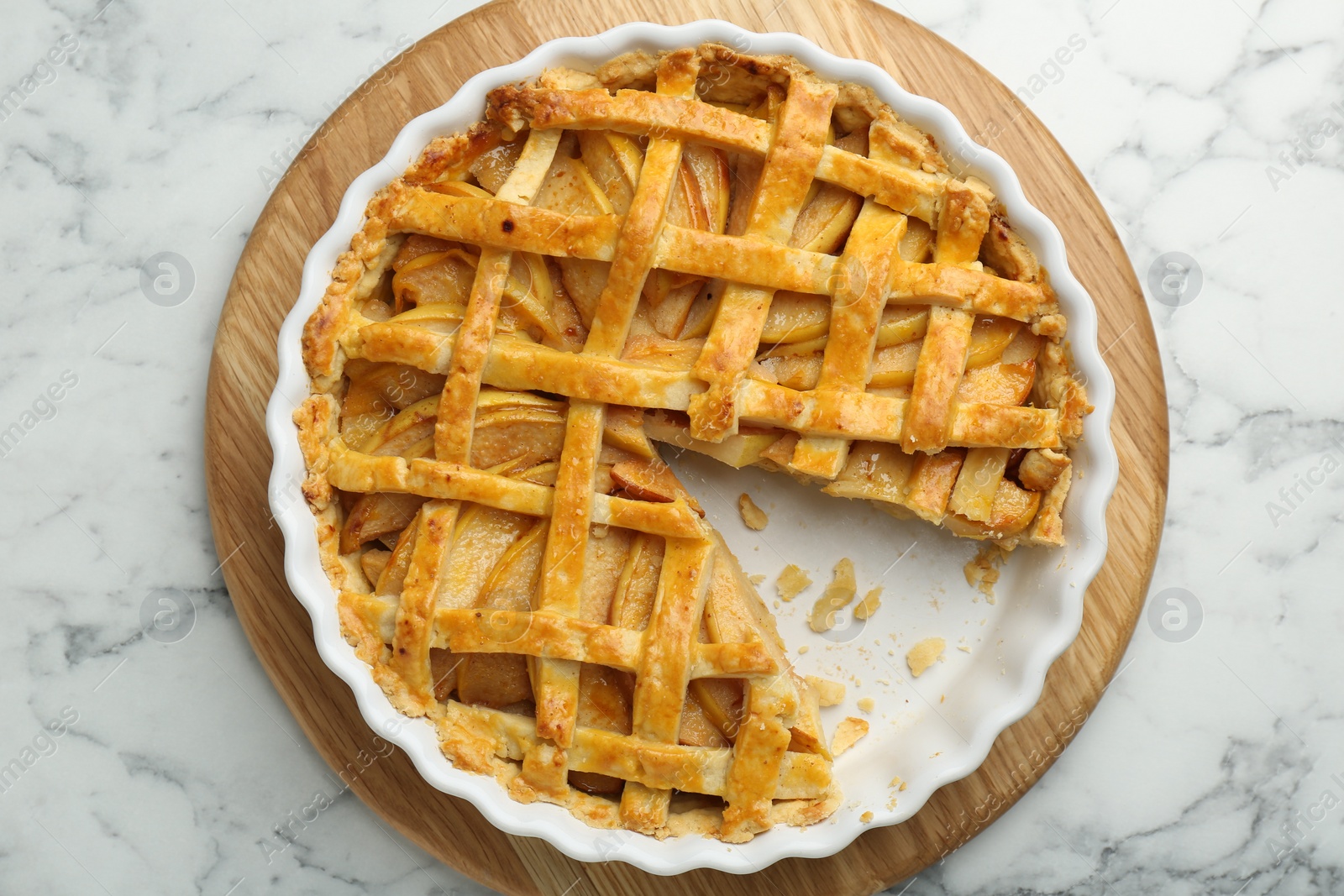 Photo of Tasty homemade quince pie on white marble table, top view