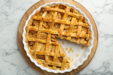 Tasty homemade quince pie on white marble table, top view