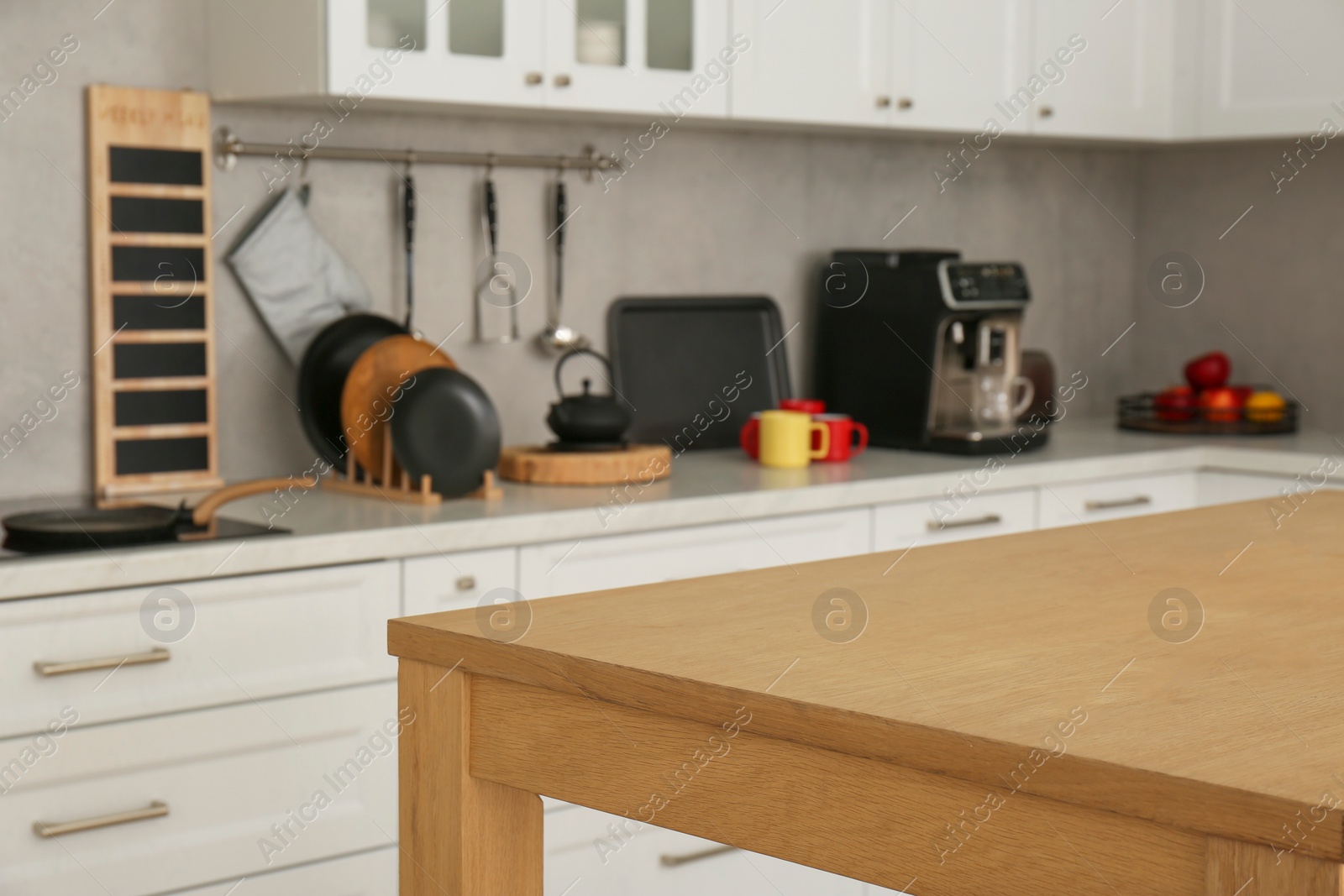 Photo of Stylish wooden table in kitchen. Interior design