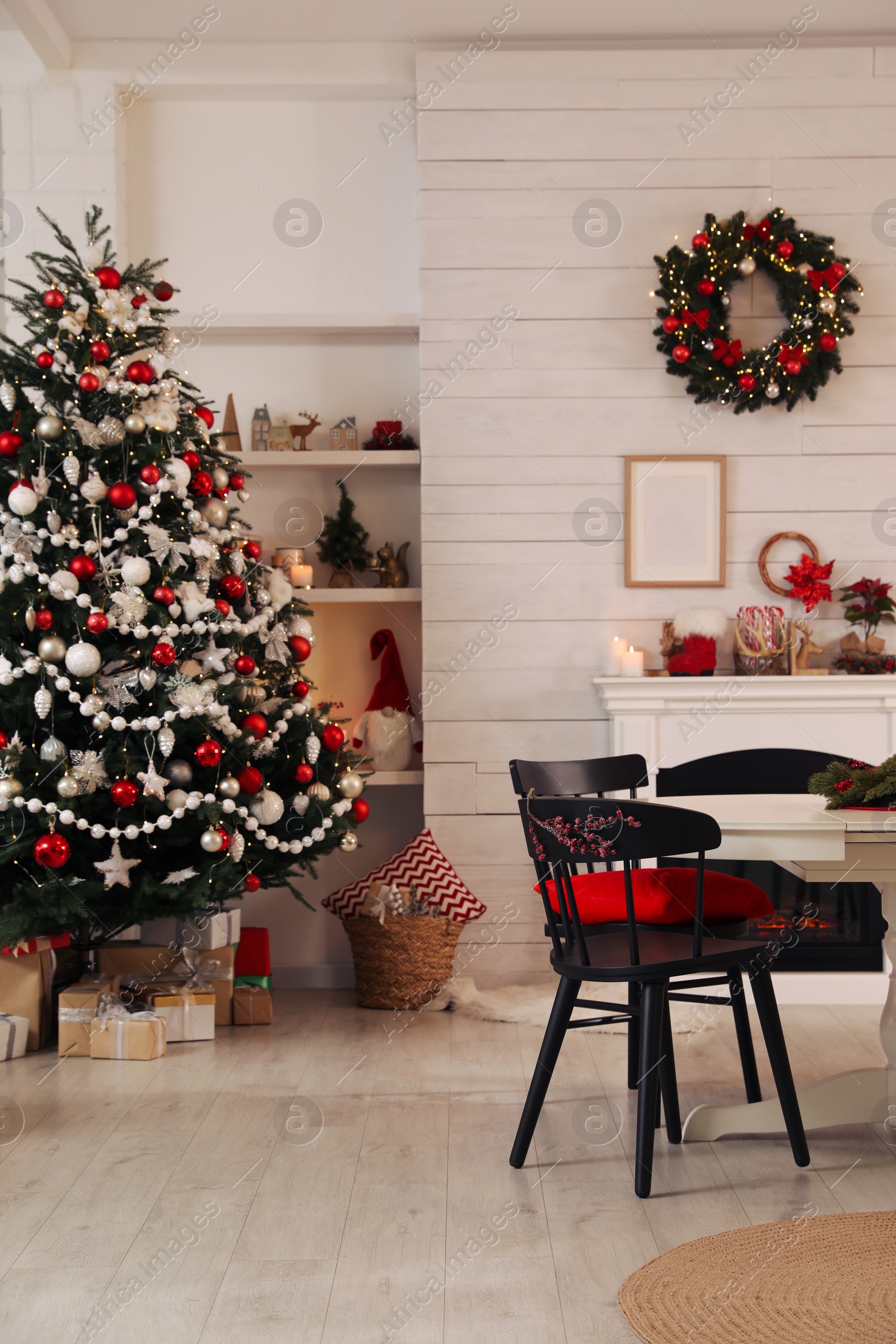 Photo of Cozy dining room interior with Christmas tree and festive decor