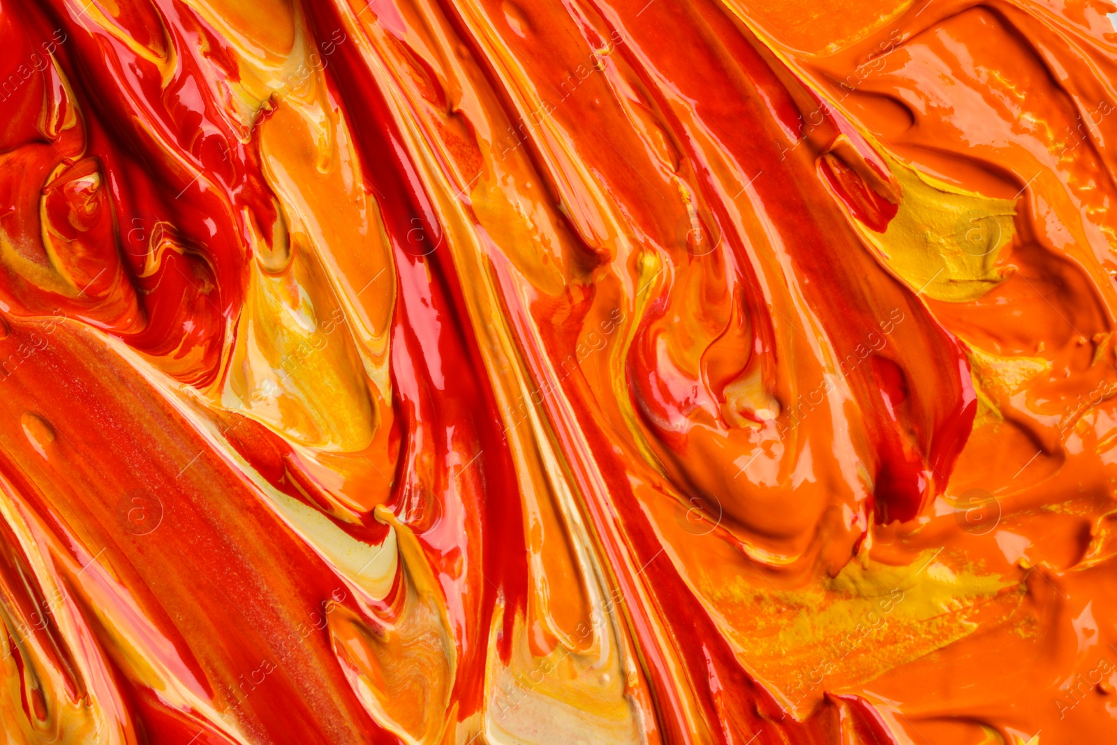 Photo of Beautiful strokes of colorful oil paints as background, closeup