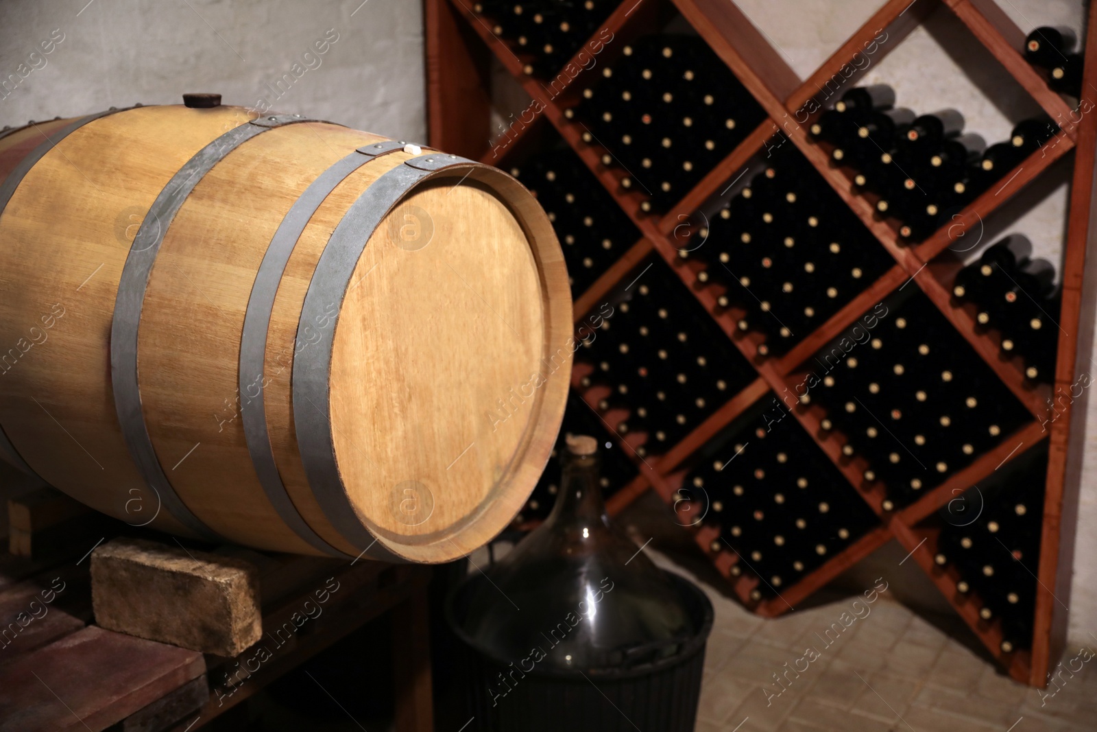Photo of Large wooden barrel on table in wine cellar
