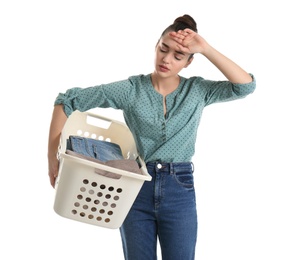 Photo of Tired young woman holding basket with laundry on white background