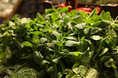 Photo of Fresh mint leaves on counter at wholesale market, closeup