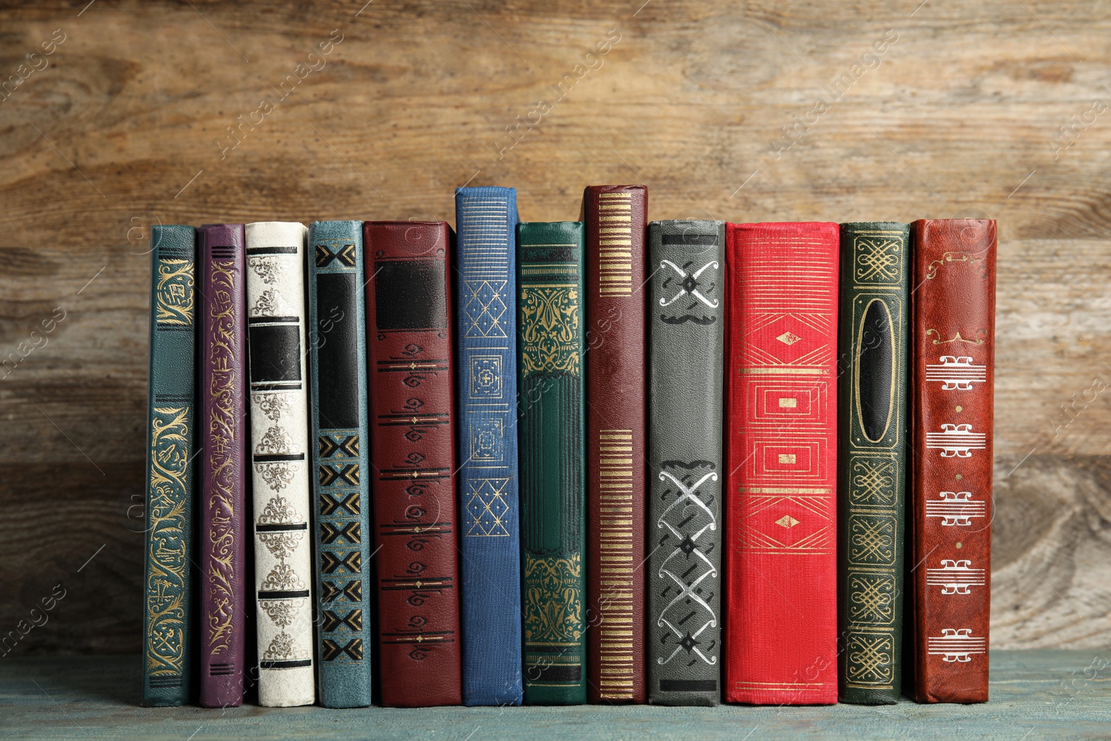 Photo of Collection of old books on wooden shelf