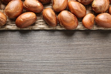 Raw jackfruit seeds on wooden table, flat lay. Space for text