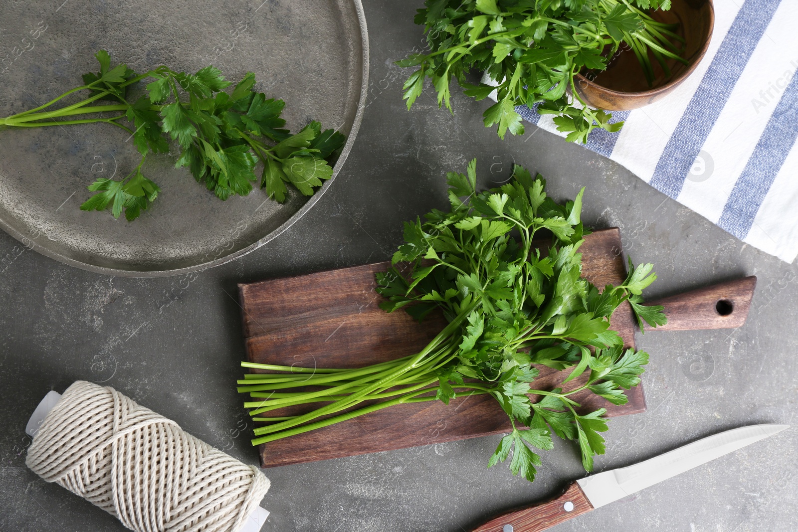 Photo of Flat lay composition with fresh green parsley on grey background