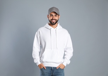 Portrait of young man in sweater on grey background. Mock up for design