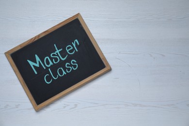 Blackboard with phrase Master class on white wooden table, top view. Space for text