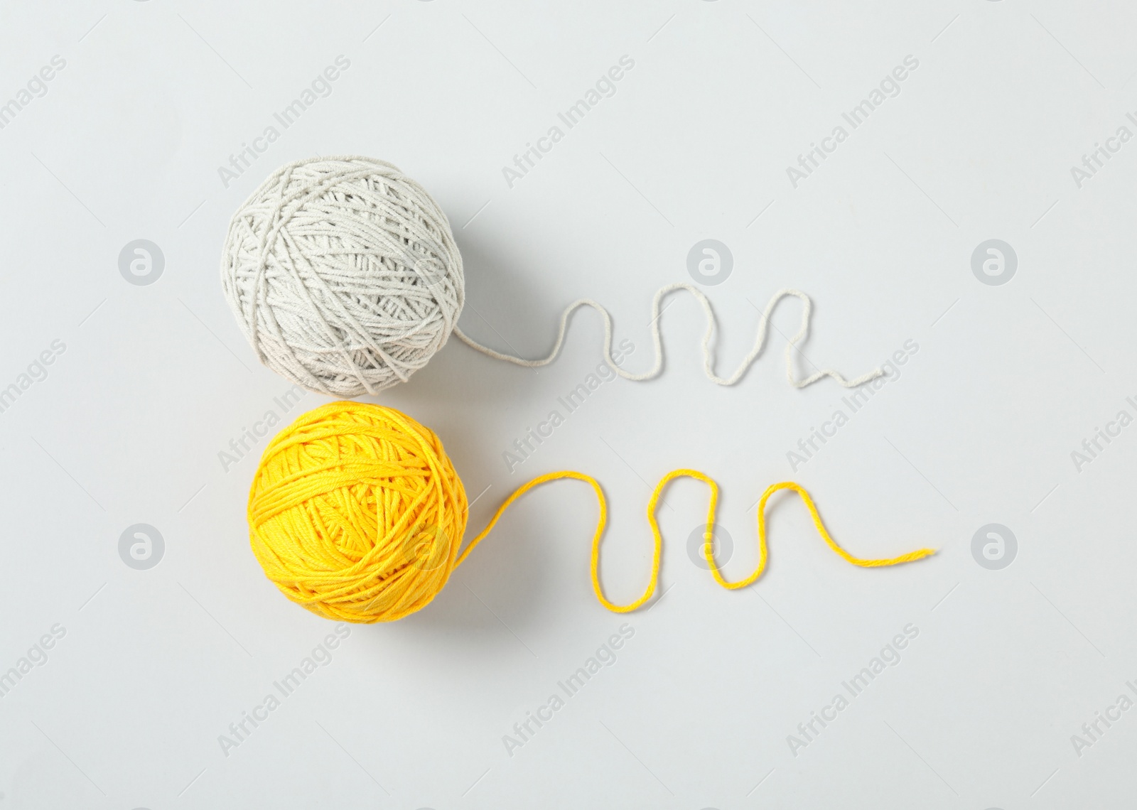 Photo of Soft colorful woolen yarns on white background, flat lay