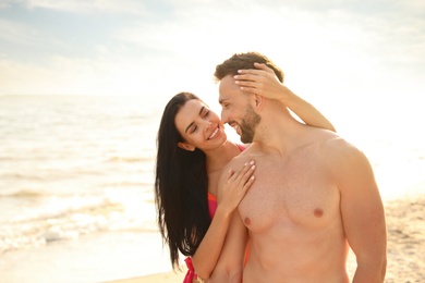 Photo of Happy young couple on beach on sunny day