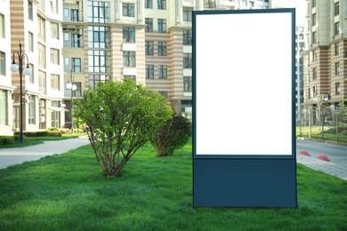 Photo of Blank advertising board on city street. Mockup for design