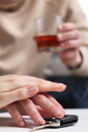 Photo of Woman stopping drunk man from taking car keys, closeup. Don't drink and drive concept