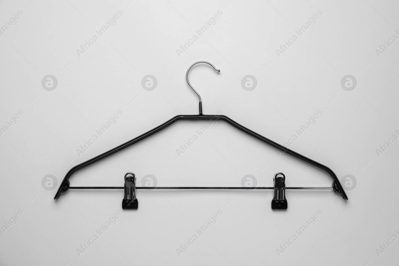 Photo of Empty hanger with clips on light grey background, top view