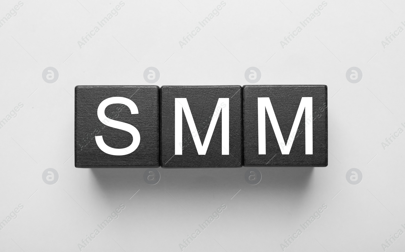 Photo of Cubes with abbreviation SMM (Social media marketing) on white background, top view