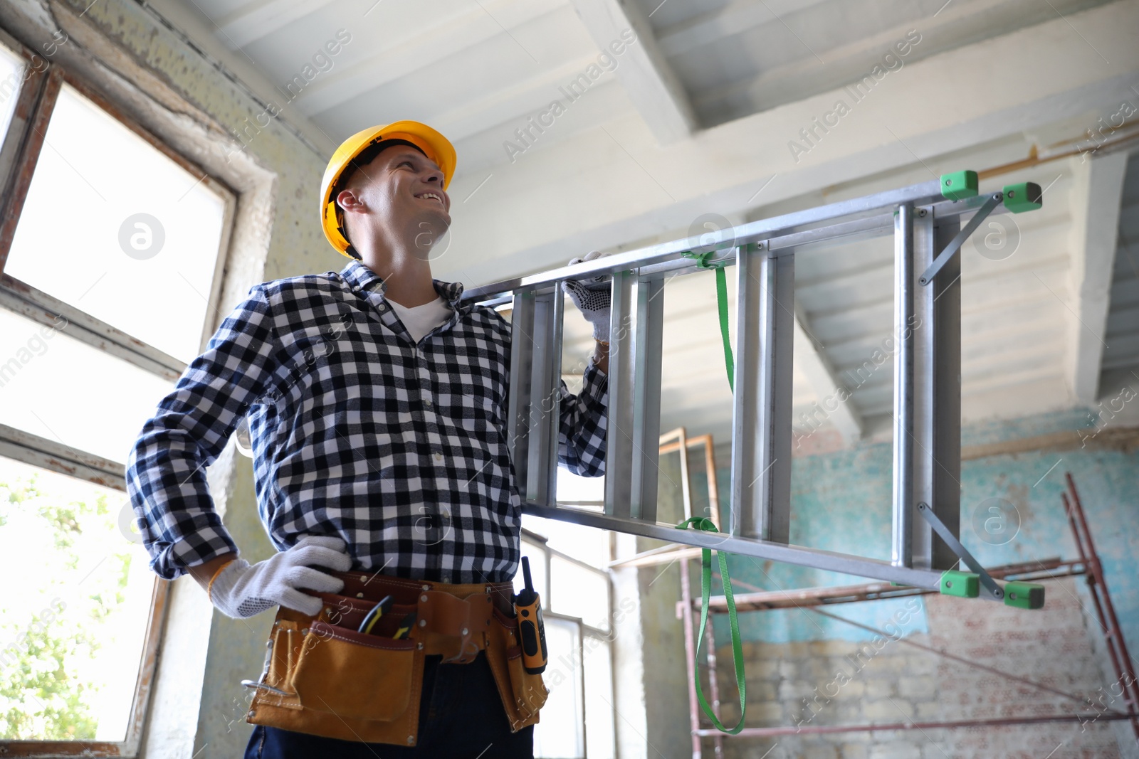 Photo of Professional constructor with ladder in old building