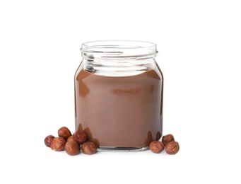 Glass jar with tasty chocolate cream and hazelnuts isolated on white