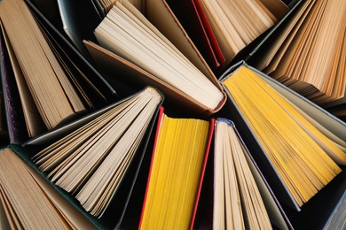 Photo of Stack of hardcover books as background, top view