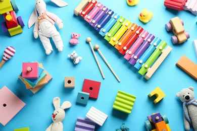 Flat lay composition with different toys on light blue background