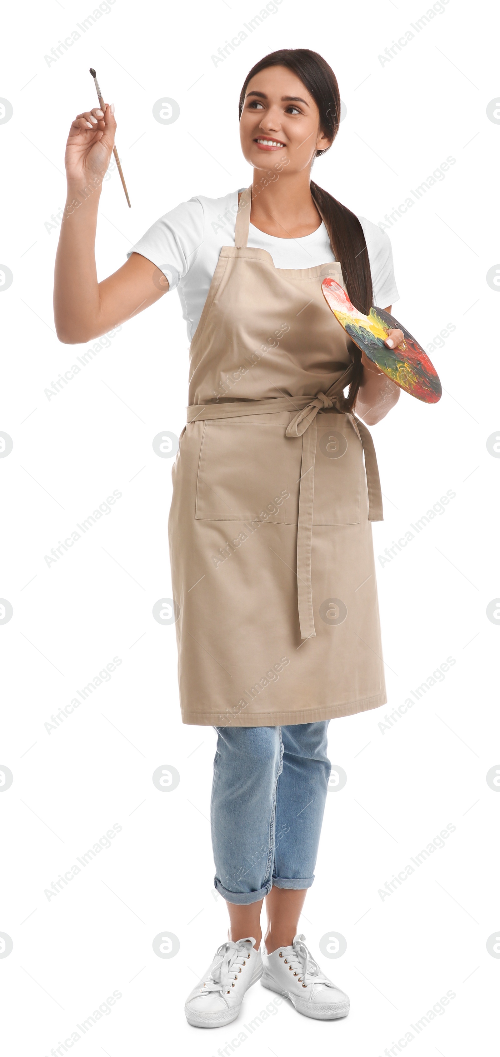 Photo of Young woman drawing with brush on white background