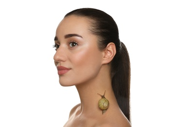 Photo of Beautiful young woman with snail on her neck against white background
