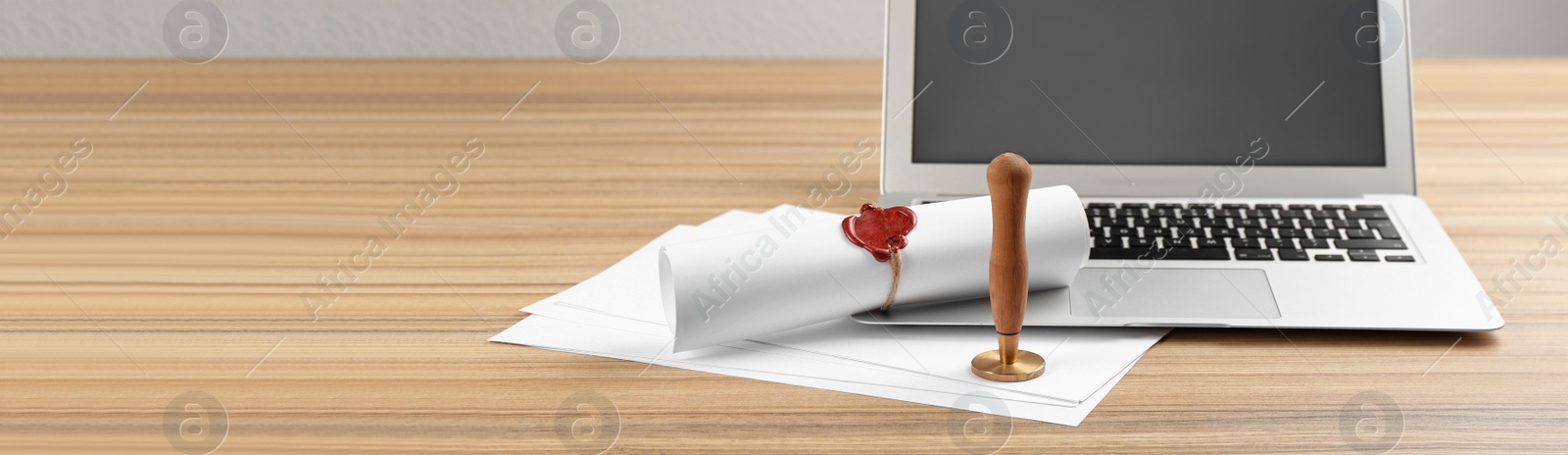 Image of Notary's public pen and sealed document near laptop on wooden table, space for text. Banner design